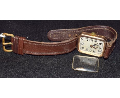 An Art Deco 1930's 9ct gold cased wrist watch, canted rectangular textured silver dial. Arabic numerals, minute track, subsid