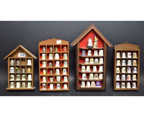 A collection of thimbles, mostly ceramic, some metal, cloisonne, etc, with four thimble display cases