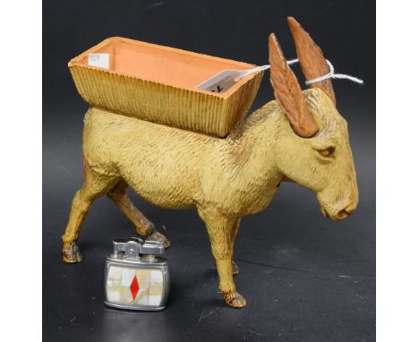 A novelty plastic donkey cigarette dispenser; a lady's mother-of-pearl inlaid pocket cigarette lighter (2)
