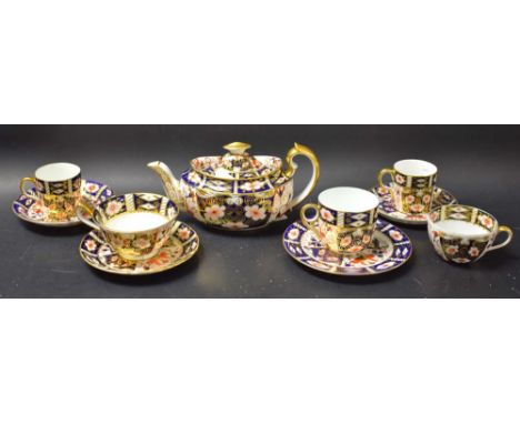 A Royal Crown Derby 2451 pattern tea set, comprising teapot, five assorted cups, three saucers, one tea plate