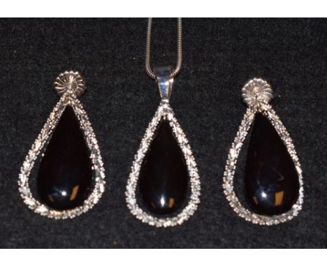 An Italian BKP pendant necklace, black teardrop stone within a white metal chain link surround, suspended from a white gold s