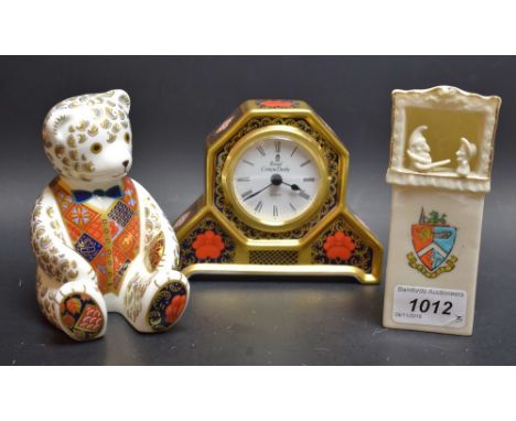 A Royal Crown Derby paperweight, Teddy Bear, silver stopper; an Imari mantel clock; a Crested ware Punch and Judy (3)