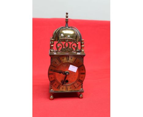 A Smiths brass cased reproduction lantern clock with pierced and engraved decoration, 10.5cm dial with Roman numerals