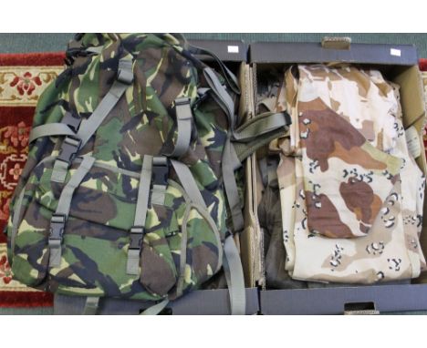 Two boxes of Army surplus - NATO camouflage, combat jackets, trousers, helmet covers, mitts, tank overalls and a backpack, mo