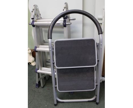 A set of folding metal step ladders with another similar set