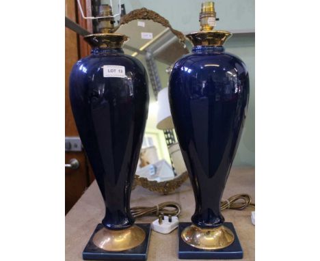 A pair of blue and gilt ceramic lamp bases