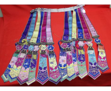 A belt of embroidered, multi silk and embroidered hanging sash panels