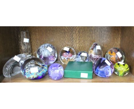 A shelf of twelve Glass Paperweights Caithness etc