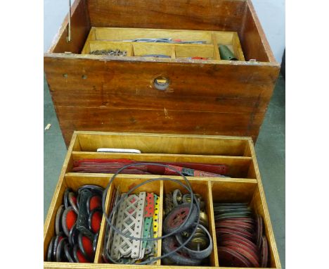 A collection of vintage Meccano in a cabinet 