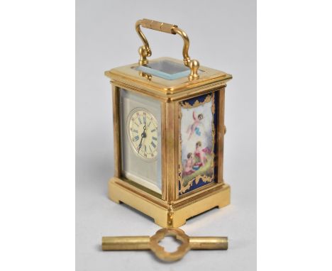 A Reproduction Gilt Cased Sevres Style Miniature Carriage Clock with Panels Decorated with Cherubs, Working Order, 7.5 cms Hi