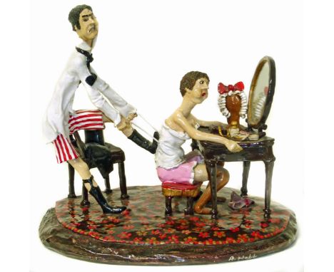 Resin hand painted comical figureen signed R. Webb depicting a man tugging on a corset. Condition reports are not available f
