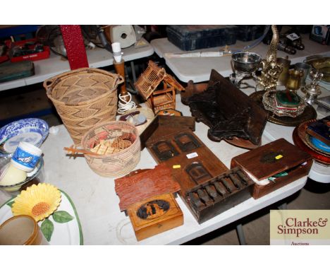 A quantity of wooden items to include a dug out bowl, a wall bracket, wooden table lamp, wicker baskets etc.