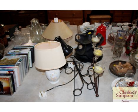 A quantity of tea light holders; an unusual bottle rack; two table lamps; and a reading lamp