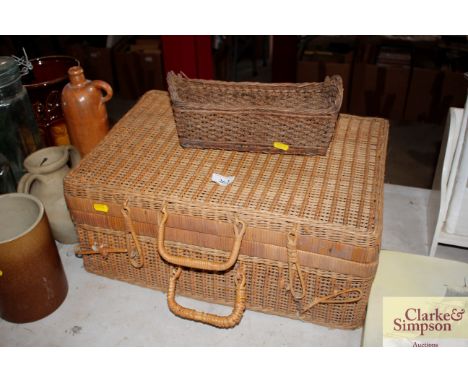 A wicker picnic hamper lacking contents together with a wicker bottle holder
