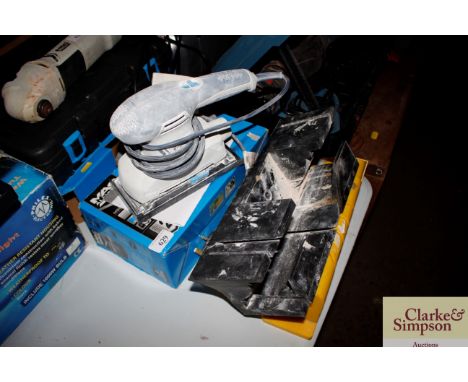 A MacAllister orbital sander; and two plastic saw holders