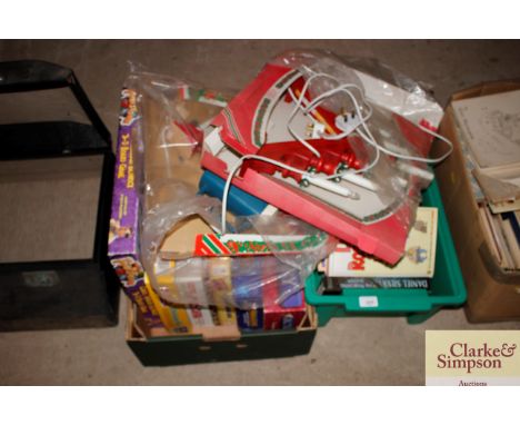 Two boxes containing various games; books; a Christmas light etc