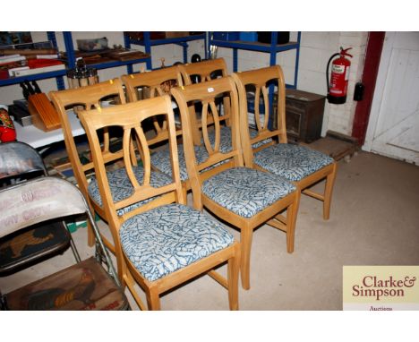 A set of six light oak dining chairs 