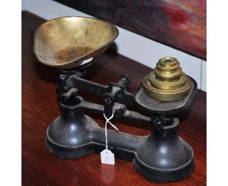 Vintage cast iron scales with a set of brass weights