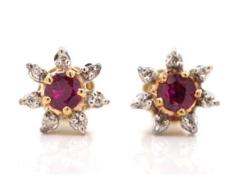 Ruby and diamond set 18ct gold cluster earrings marked 750 to yellow gold screw backs. Approx weight 2.7 grams