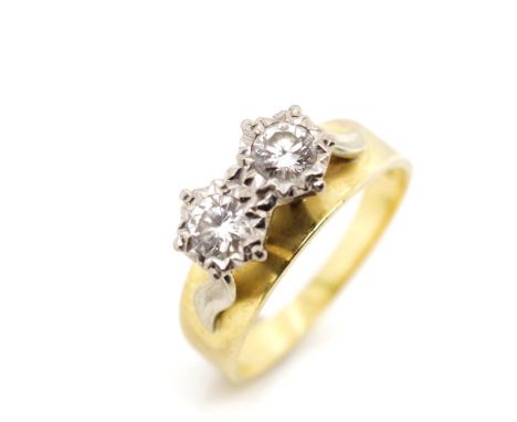 Two stone diamond set 18ct yellow gold ring with a raised white gold setting. Marked 18ct. Approx weight 4.4 grams, ring size