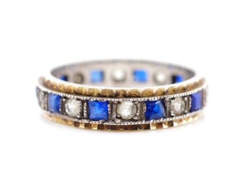 9ct gold and silver eternity ring set with blue and white gemstones. Marked 9ct Sil. Approx ring size J