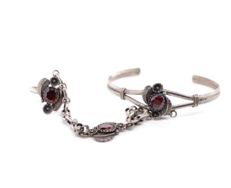 Silver bangle and ring combination set with red gemstones in feather form mounts. Marked 925. Approx bracelet width 55mm