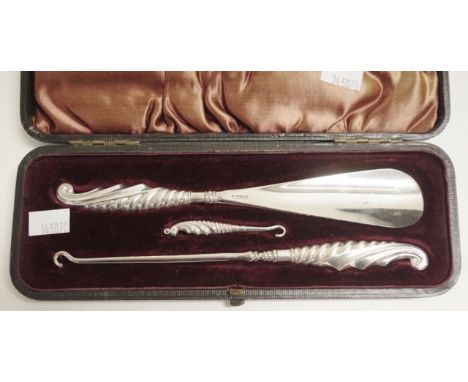 Vintage cased three piece shoe horn set including shoe horn, button hook, and shoe hook, marked Sterling, in original fitted 