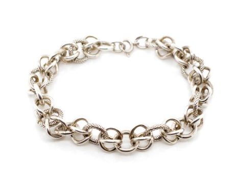 An unusual silver chain bracelet with alternate figure eight and textured chain links. With miss struck silver mark to bracel