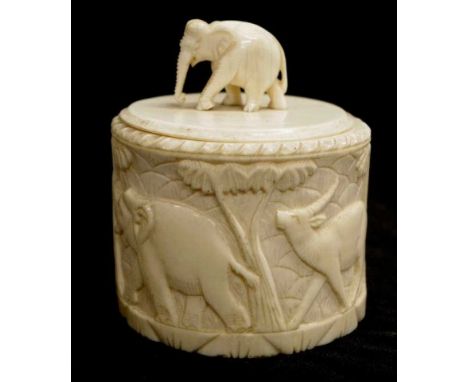 Antique carved ivory lidded box carved elephant, lion, and camel decoration to sides, carved elephant figure to lid, (height 