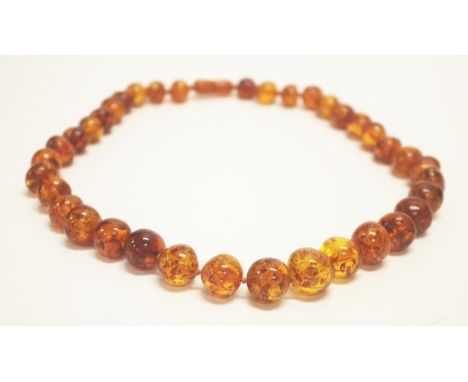 Vintage string of graduated amber beads length 26cm approx