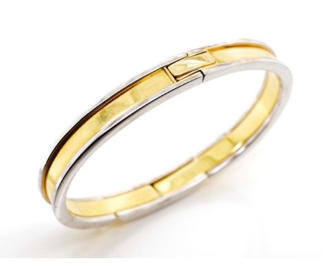 Two tone 18ct gold bangle of oval shape with two articulate hinges and push button clasp. 8mm flat wire with yellow gold high