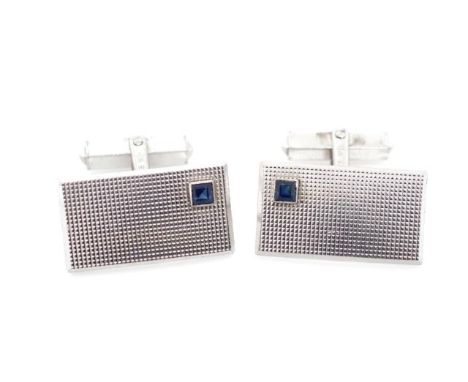 14ct white gold and sapphire cufflinks with engine turned panels. Marked with Austrian dog head 54 marks to wind back fitting
