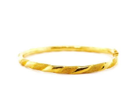 Oriental yellow gold bangle marked 9999. Approx 14 grams, inside width 58mm, with swivel hinge and clasp. The shape is off ro