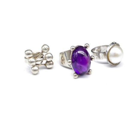 Three Modernist silver rings set with an amethyst, Mabe pearls or mounted with bead work. Approx weight 32 grams, ring size J