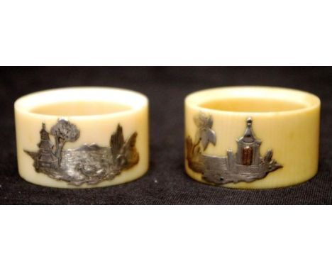 Pair vintage Oriental ivory napkin rings each with applied Eastern temple scene decoration. NOTE: Export of these items is no