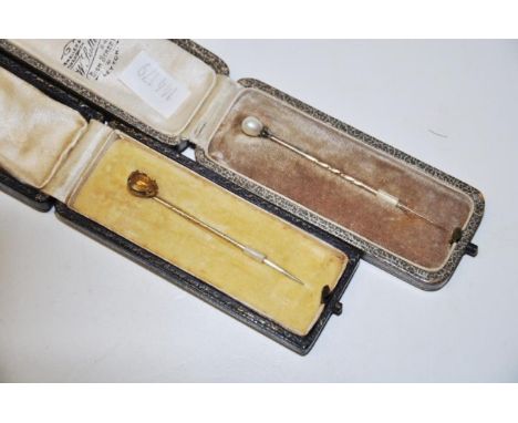 Two vintage cased cravat/tie pins one topped with a pearl &amp; the other with a yellow gemstone