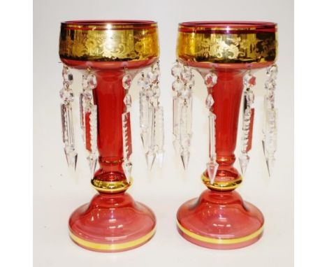 Pair vintage red glass lustre vases each with gilt decoration to red glass vases, suspended lustres to circular foot to each,