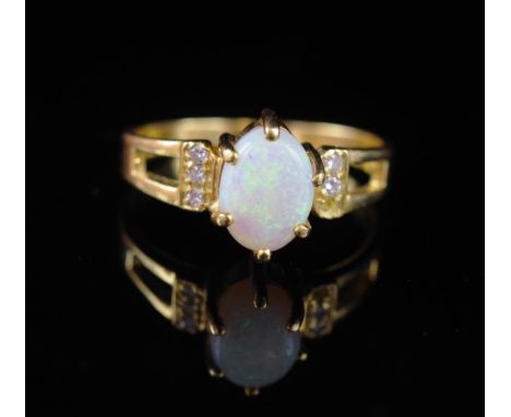 Opal and diamond set 18ct yellow gold ring marked 750. Approx weight 3.2 grams, ring size N. Missing a diamond