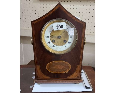 An Edwardian inlaid mahogany cased mantel clock with swept gabled top, flanking ring handles and French 'silver medal' eight 