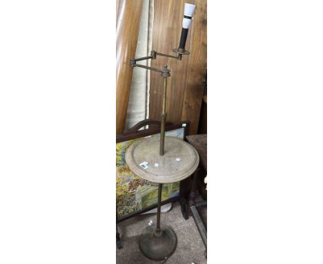 An old brass mounted reading candle lamp wine table with articulated arm and circular oak surface, set on slender pillar and 