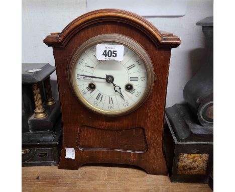 An Edwardian mahogany cased mantel clock with break arched top, bi-numeral dial and HAC eight day gong striking movement