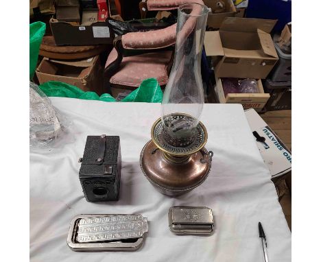 A crate containing a quantity of collectable items including copper oil lamp, Zeiss Ikon camera, etc.