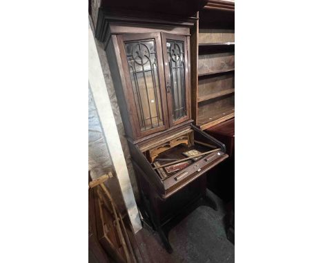 A 72cm early 20th Century stained walnut Lebus bureau/bookcase with pair of fretwork decorated glazed panel doors over a tamb