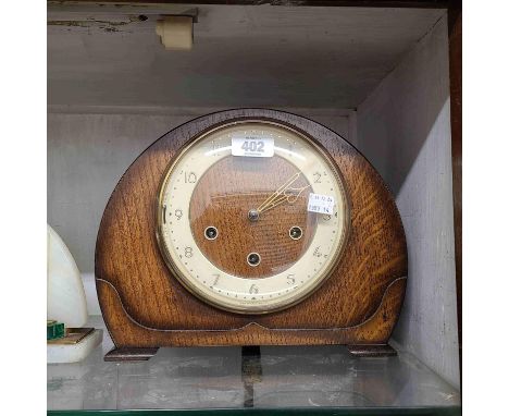 A vintage oak cased mantel clock with Smiths eight day chiming movement