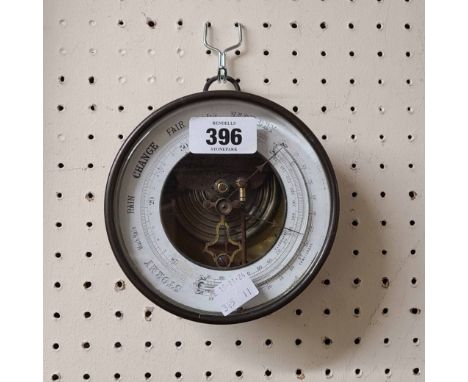 An antique brass cased sedan style wall barometer with suspender loop, visible aneroid works and curved thermometer tube