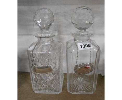 Two cut glass spirit decanters each with a silver label one for 'Cognac' and the other 'Champagne'