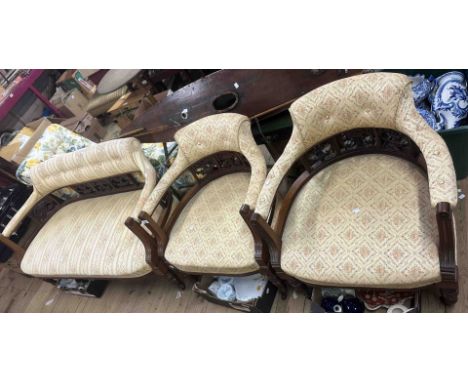 An Edwardian three piece parlour suite comprising a 1.3m two seater settee and two tub chairs, all with button back tapestry 