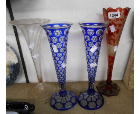 A 19th Century Ruby glass flute vase with flash engraved decoration, depicting a stag amidst foliage - sold with a pair of bl