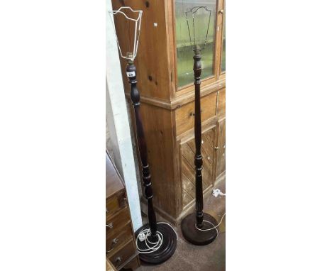 Two stained wood standard lamps, both with turned pillar and circular base