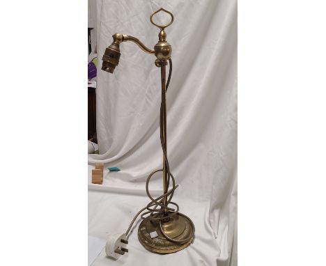 A Christopher Wray brass table lamp of sliding form